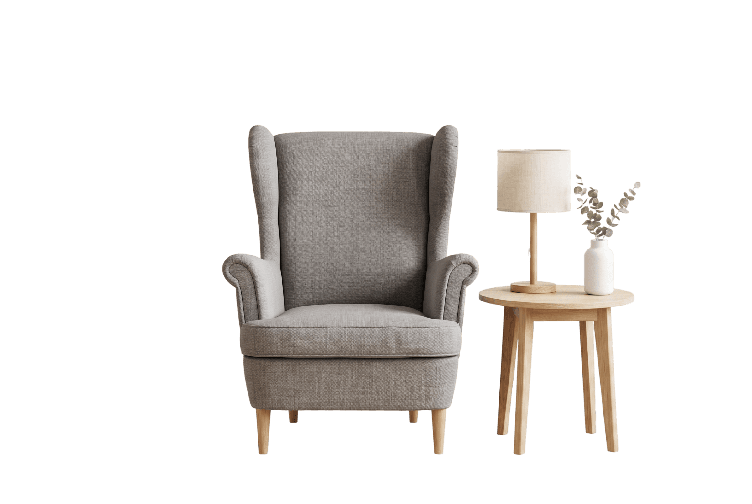 Grey wingback armchair with a table lamp on a wooden side table and a vase of dried stems
